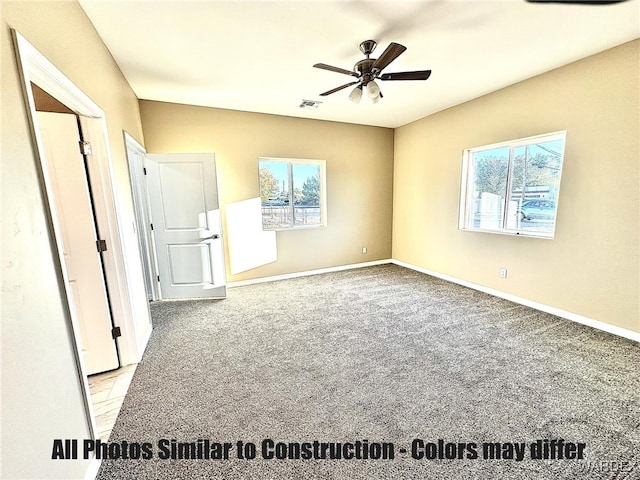 unfurnished bedroom featuring baseboards, visible vents, carpet flooring, and multiple windows