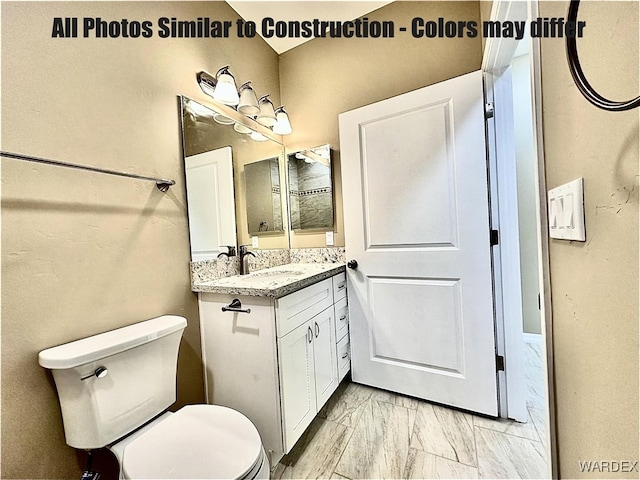 bathroom featuring marble finish floor, vanity, and toilet