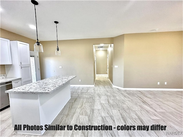 kitchen featuring light stone counters, a center island, pendant lighting, stainless steel dishwasher, and white cabinetry