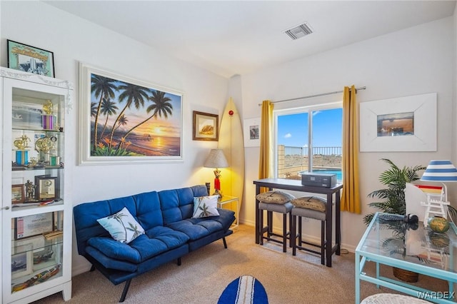 living room with visible vents, light carpet, and baseboards