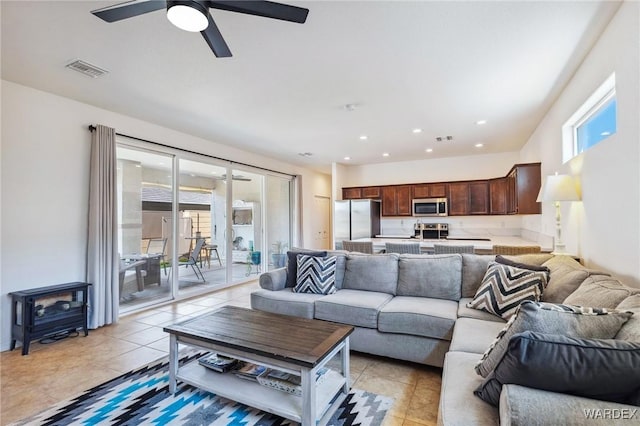 living room featuring light tile patterned floors, visible vents, and recessed lighting