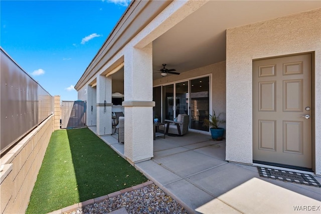 exterior space featuring ceiling fan and a fenced backyard