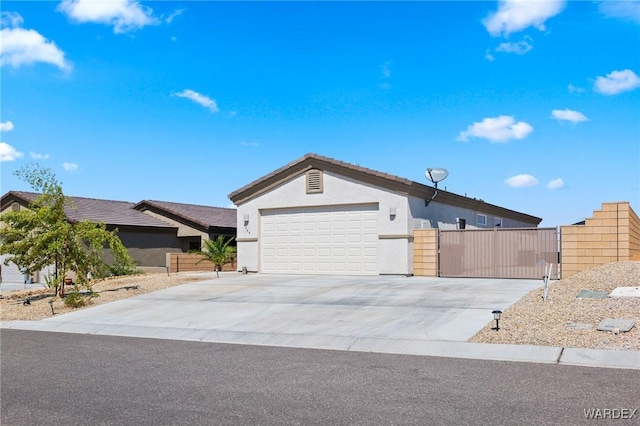 ranch-style house featuring a garage, concrete driveway, and stucco siding