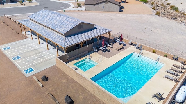 view of swimming pool featuring fence