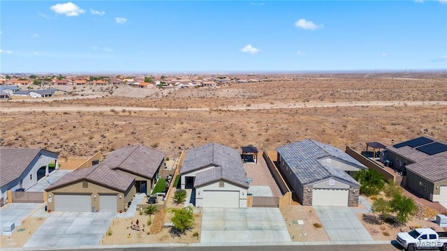 drone / aerial view featuring a residential view and a desert view