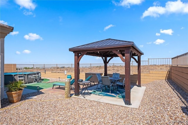 view of patio featuring a gazebo, a fenced backyard, and a fenced in pool