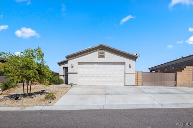 single story home featuring an attached garage, concrete driveway, and stucco siding