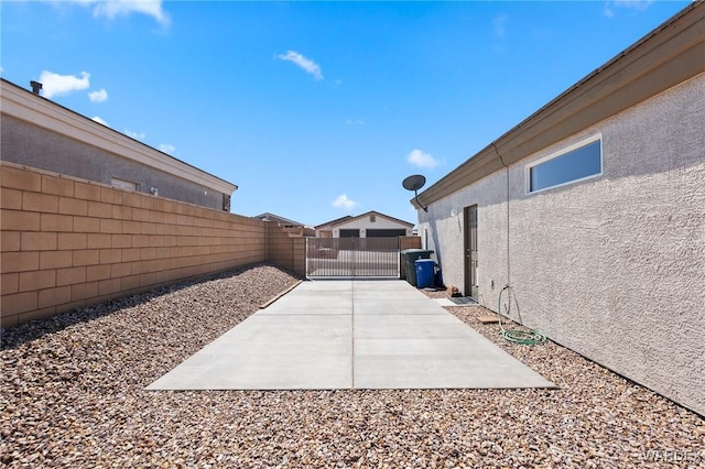 view of patio featuring a gate and fence