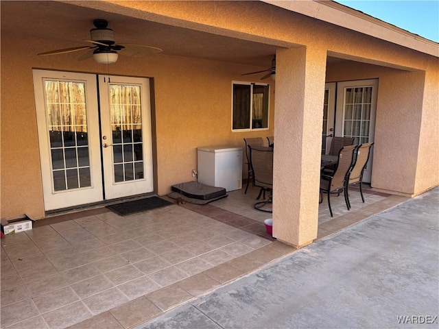 view of patio / terrace featuring french doors, outdoor dining space, and a ceiling fan