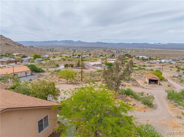 birds eye view of property with view of desert, a mountain view, and a residential view