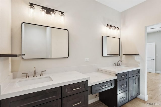 bathroom featuring vanity and baseboards