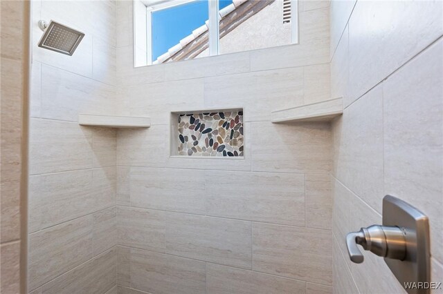 full bath featuring tiled shower