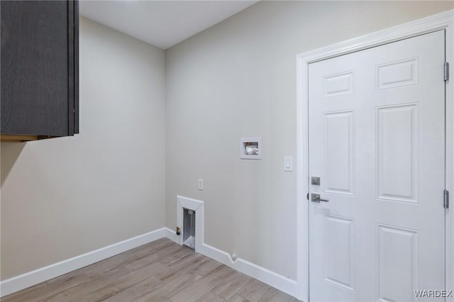 washroom featuring laundry area, washer hookup, light wood-type flooring, and baseboards