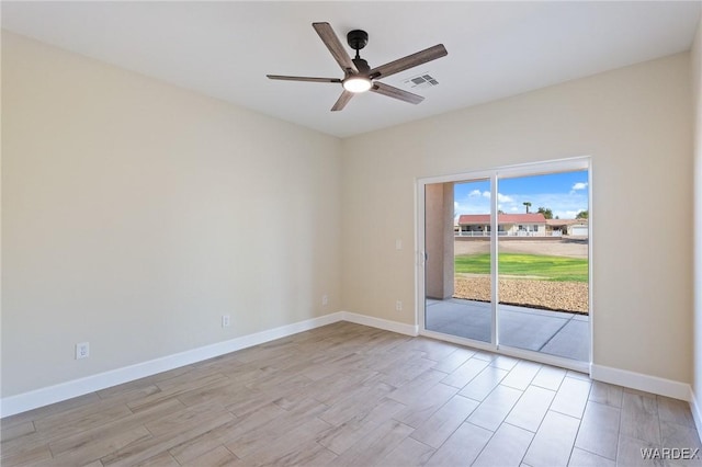 empty room featuring baseboards, visible vents, ceiling fan, and light wood finished floors