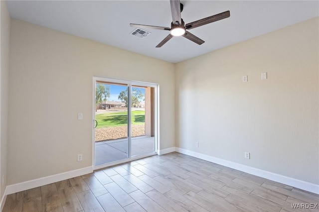 unfurnished room featuring light wood finished floors, visible vents, baseboards, and a ceiling fan