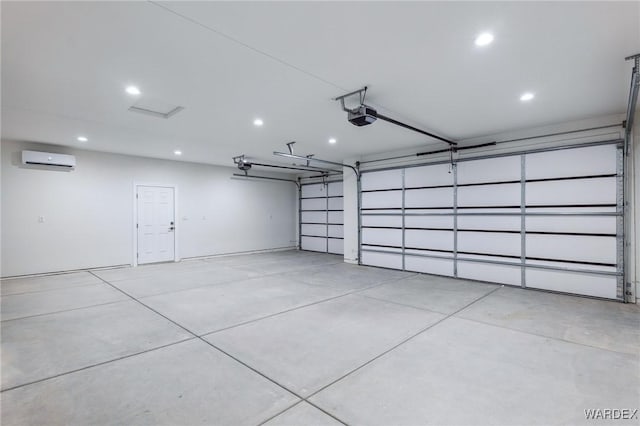 garage with a garage door opener, recessed lighting, and an AC wall unit