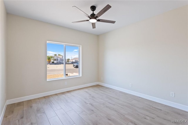 empty room featuring a ceiling fan, light wood-style flooring, and baseboards