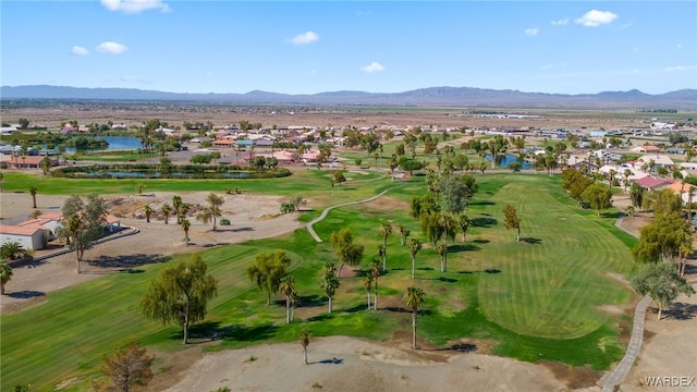 drone / aerial view featuring view of golf course, a water and mountain view, and a residential view