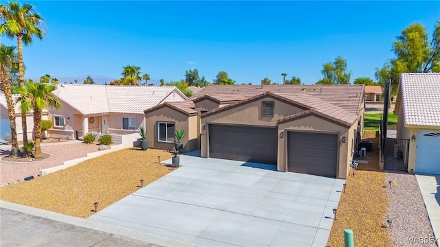 ranch-style home with an attached garage, fence, a tile roof, concrete driveway, and stucco siding