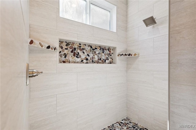 bathroom featuring a tile shower