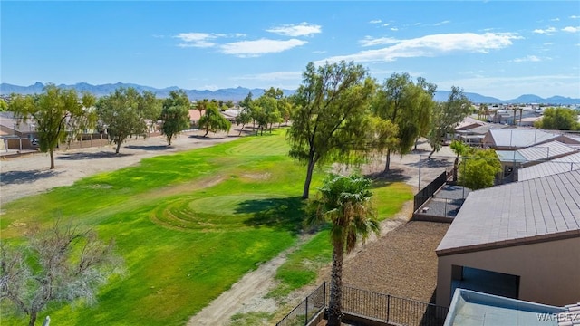 view of home's community with fence, a mountain view, and golf course view