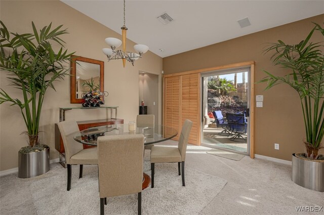 dining area featuring light colored carpet, visible vents, an inviting chandelier, vaulted ceiling, and baseboards