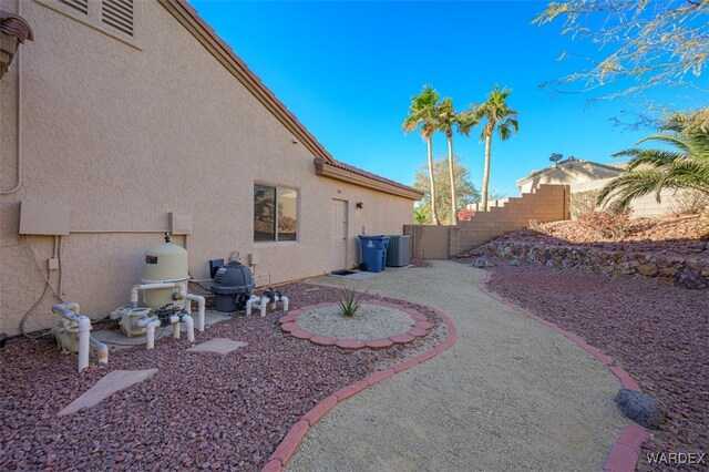 view of yard with a fenced backyard and central AC unit