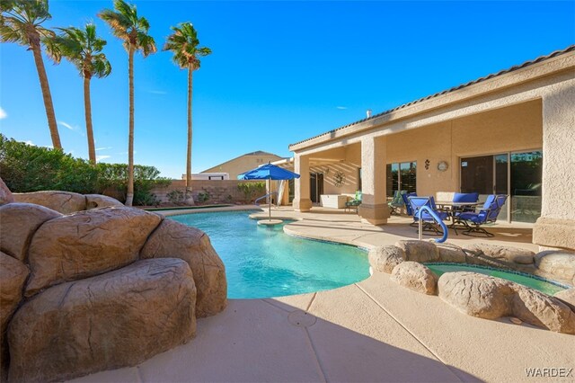 view of pool with a fenced in pool, a patio area, fence, and a jacuzzi