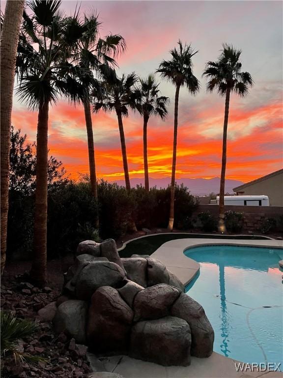 pool at dusk with an outdoor pool