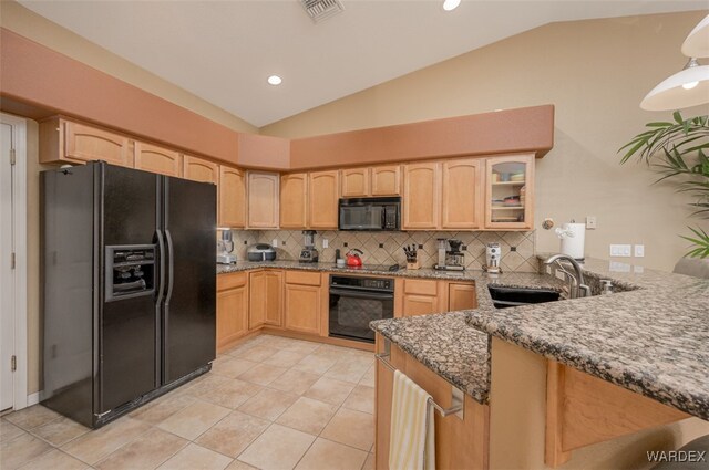 kitchen featuring visible vents, glass insert cabinets, light brown cabinetry, black appliances, and a sink