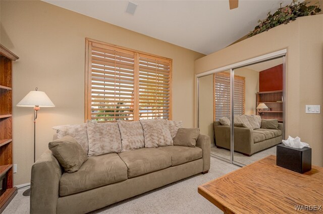 living room featuring lofted ceiling and light carpet