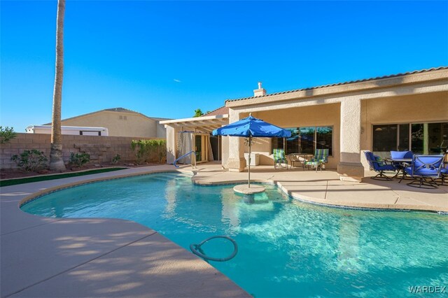 view of swimming pool with a fenced in pool, a patio area, fence, and a pergola