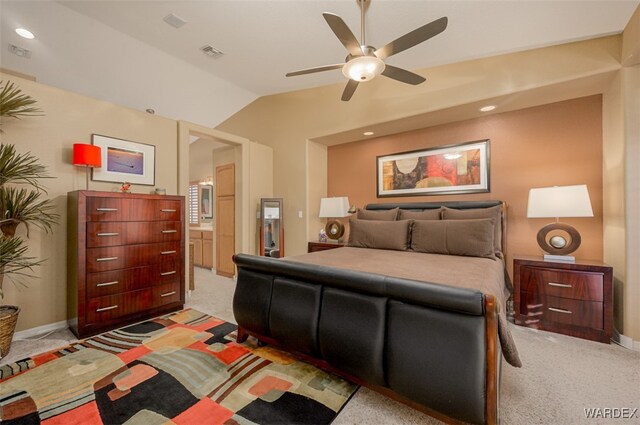 bedroom with vaulted ceiling, light carpet, visible vents, and baseboards