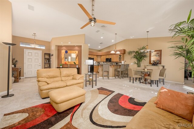 living room featuring high vaulted ceiling, light colored carpet, and baseboards