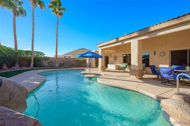 view of swimming pool with a fenced backyard, a fenced in pool, and a patio