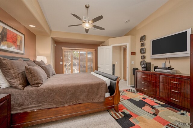 bedroom featuring lofted ceiling, a ceiling fan, and light colored carpet