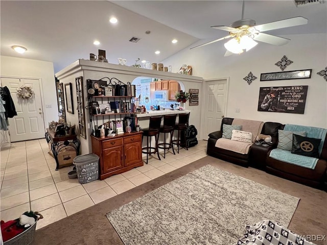 living area with light tile patterned floors, lofted ceiling, recessed lighting, visible vents, and ceiling fan