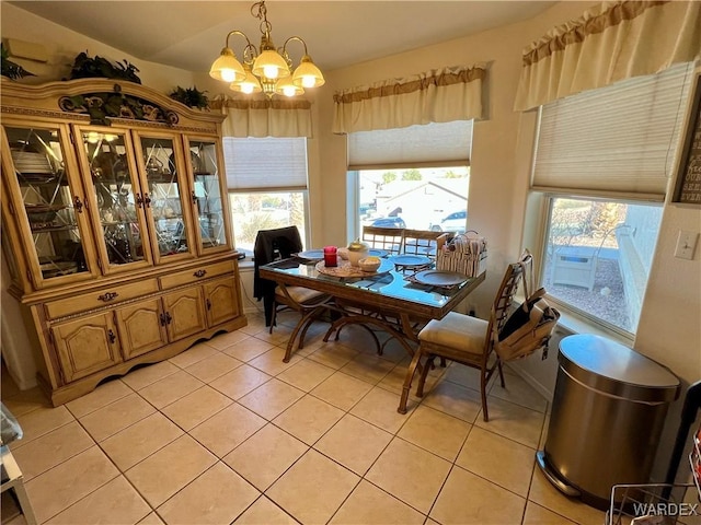 dining area featuring a notable chandelier and light tile patterned floors