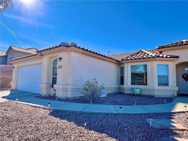 view of property exterior with a garage, a tiled roof, and stucco siding