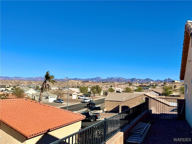 balcony featuring a residential view and a mountain view