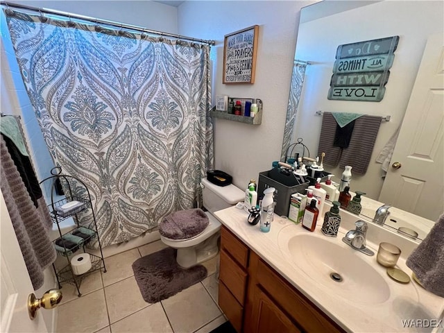 bathroom with a shower with curtain, vanity, toilet, and tile patterned floors