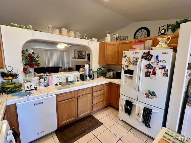 kitchen featuring tile counters, white appliances, light tile patterned flooring, and a ceiling fan