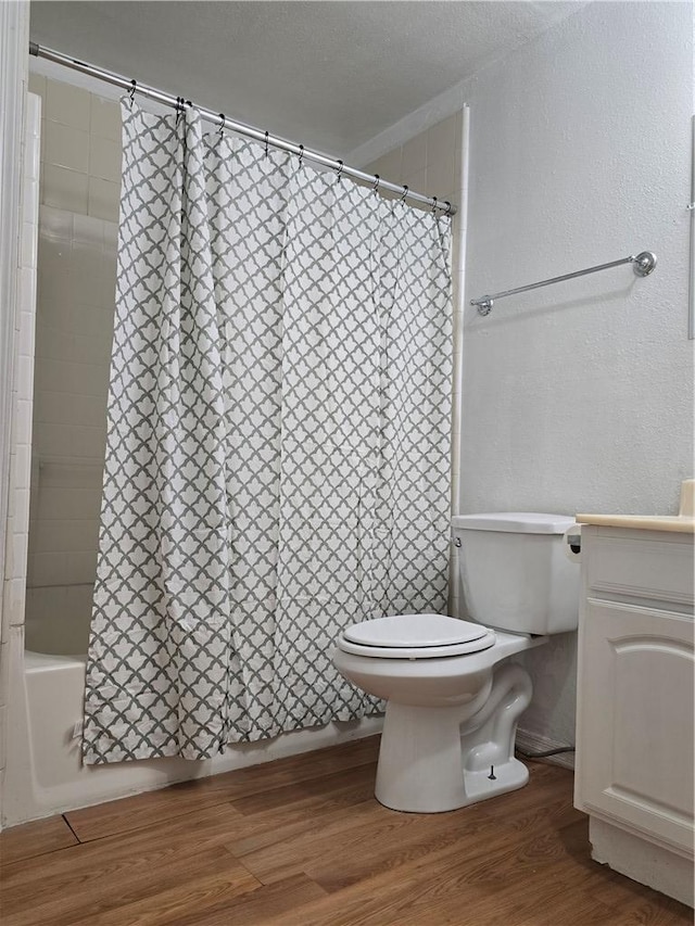 2147 Ashfork Ave, Kingman, AZ 86401 - full bathroom featuring wood finished floors, toilet, shower / tub combo, and a textured wall