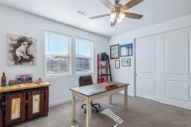 office featuring visible vents, ceiling fan, light carpet, and baseboards