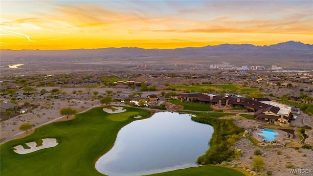 aerial view featuring view of golf course and a water and mountain view