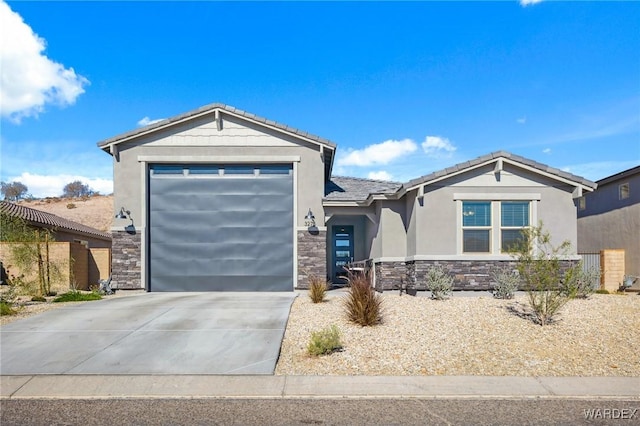 view of front facade featuring an attached garage, stone siding, concrete driveway, a tiled roof, and stucco siding