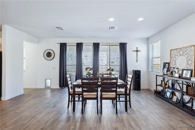 dining area featuring baseboards, visible vents, wood finished floors, and recessed lighting