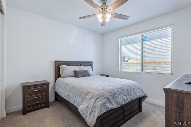 bedroom featuring baseboards, ceiling fan, and light colored carpet