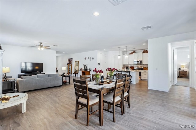 dining area featuring light wood-style floors, ceiling fan, visible vents, and recessed lighting