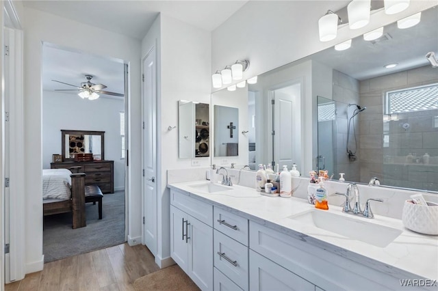 ensuite bathroom featuring double vanity, a shower stall, a sink, and ensuite bathroom